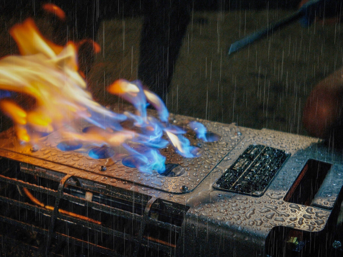 HOWL propane campfire burning in heavy rain with water beading on the A-Flame burner plate