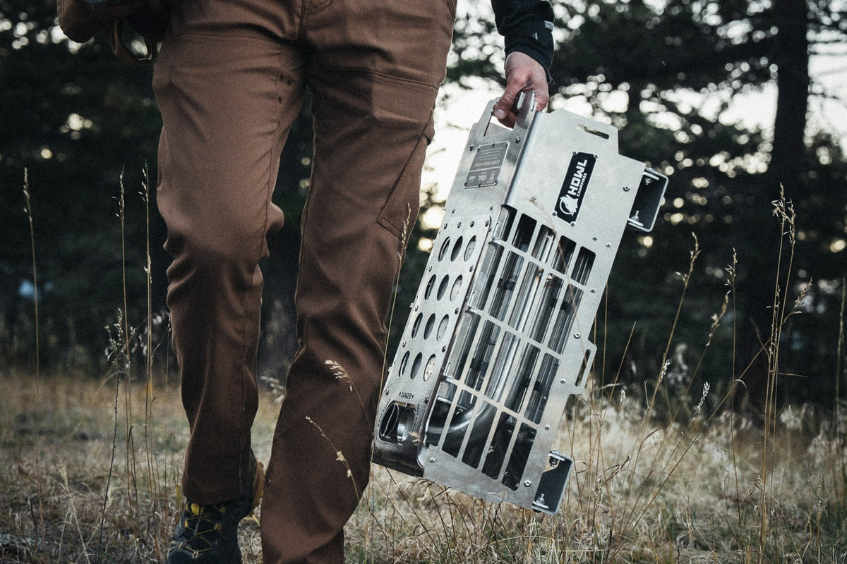 HOWL propane campfire with stainless steel Pressbrake Frame being carried through camp