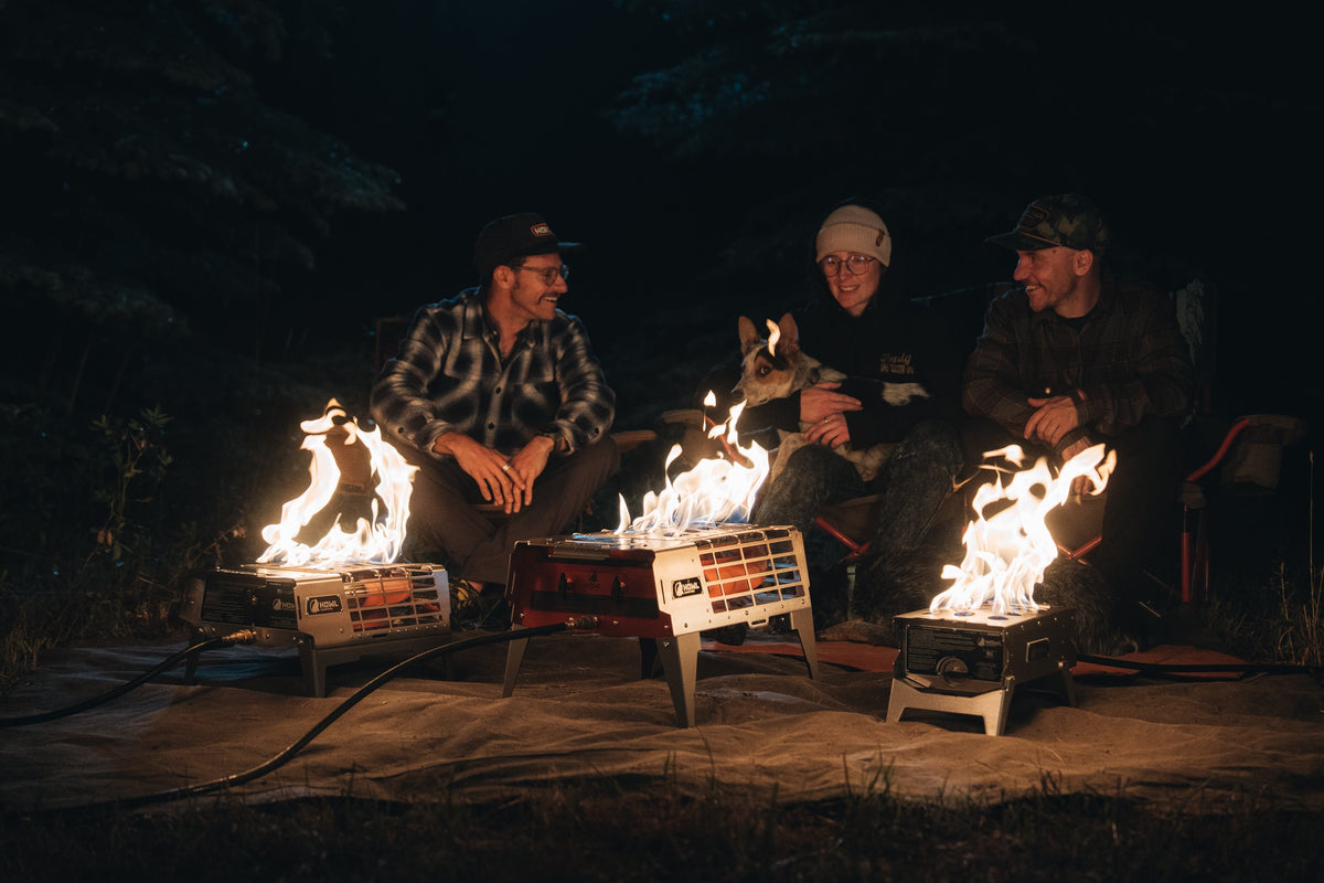 Three campers and a dog sitting around the HOWL R1, R3, and R4Mkii propane fire pits
